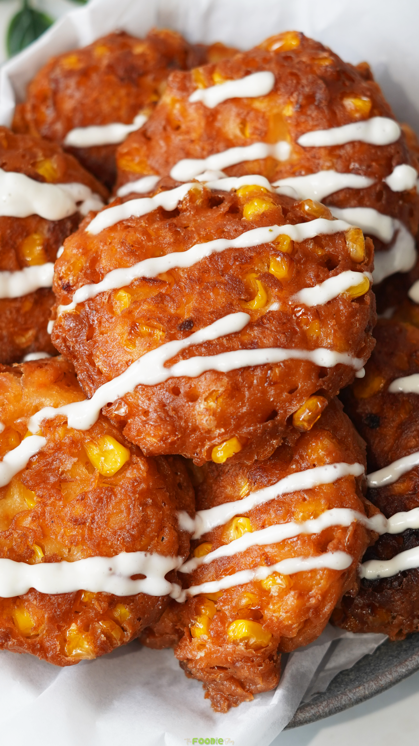 Crispy sweet corn fritters with feta drizzled with creamy sauce