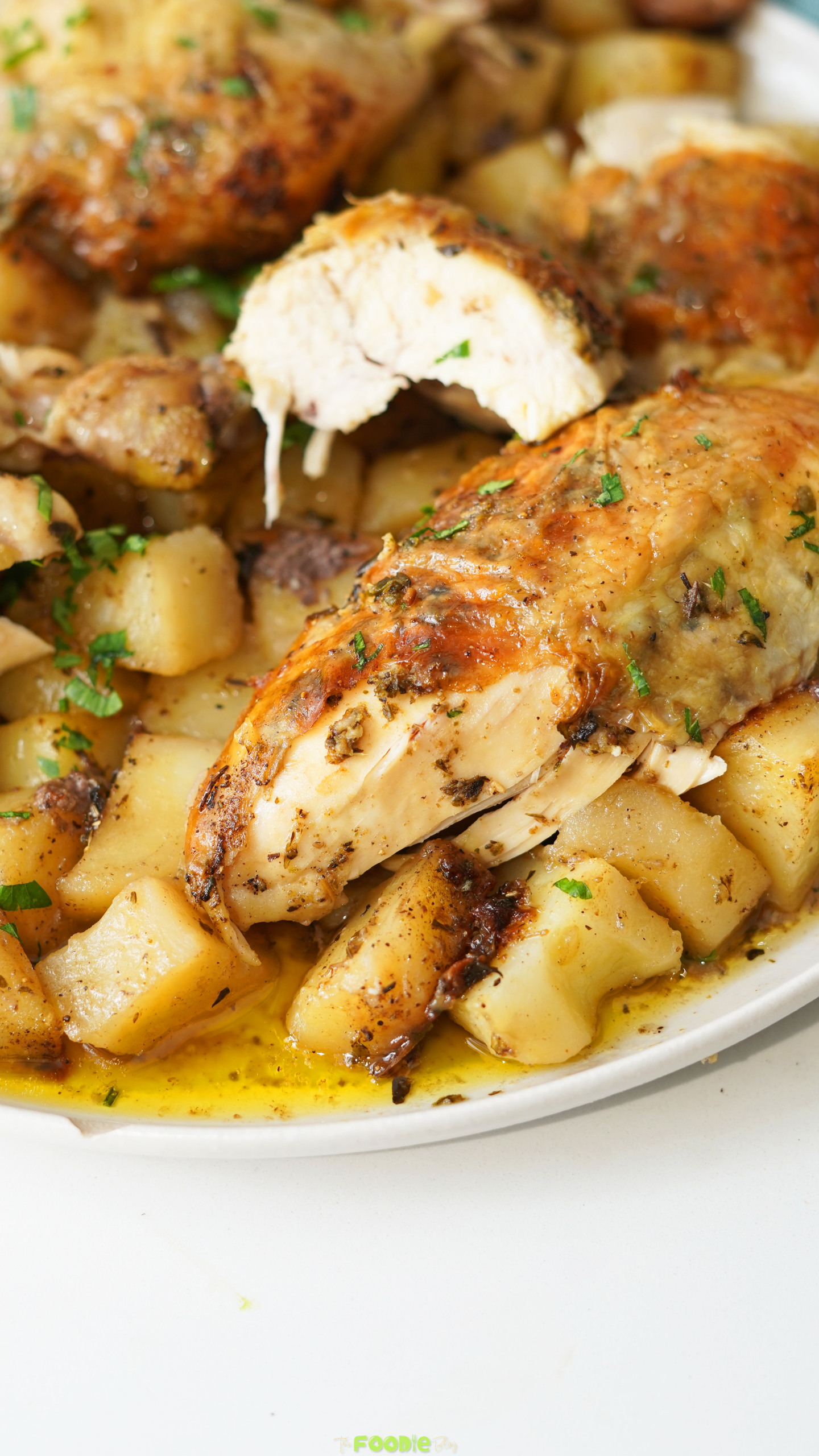 Close-up of garlic herb poulet rôti with crispy golden skin and potatoes