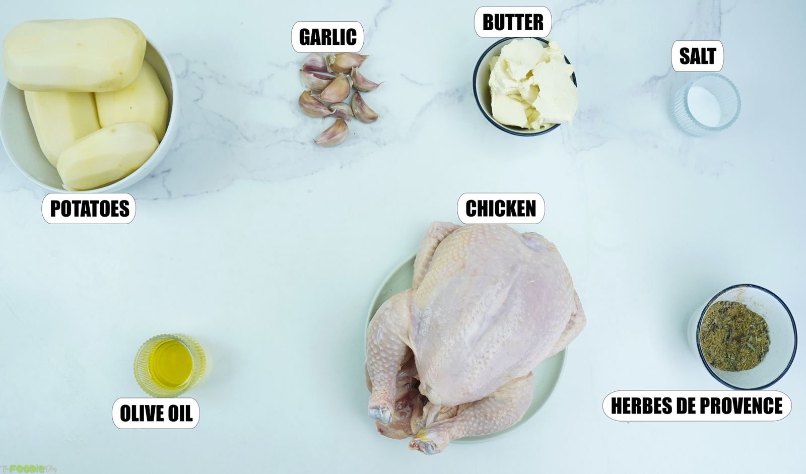 Ingredients for poulet rôti recipe with chicken, potatoes, garlic, butter and herbes de Provence