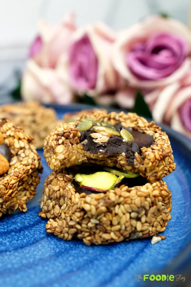 Bitten sesame banana cookie filled with dark chocolate and topped with seeds