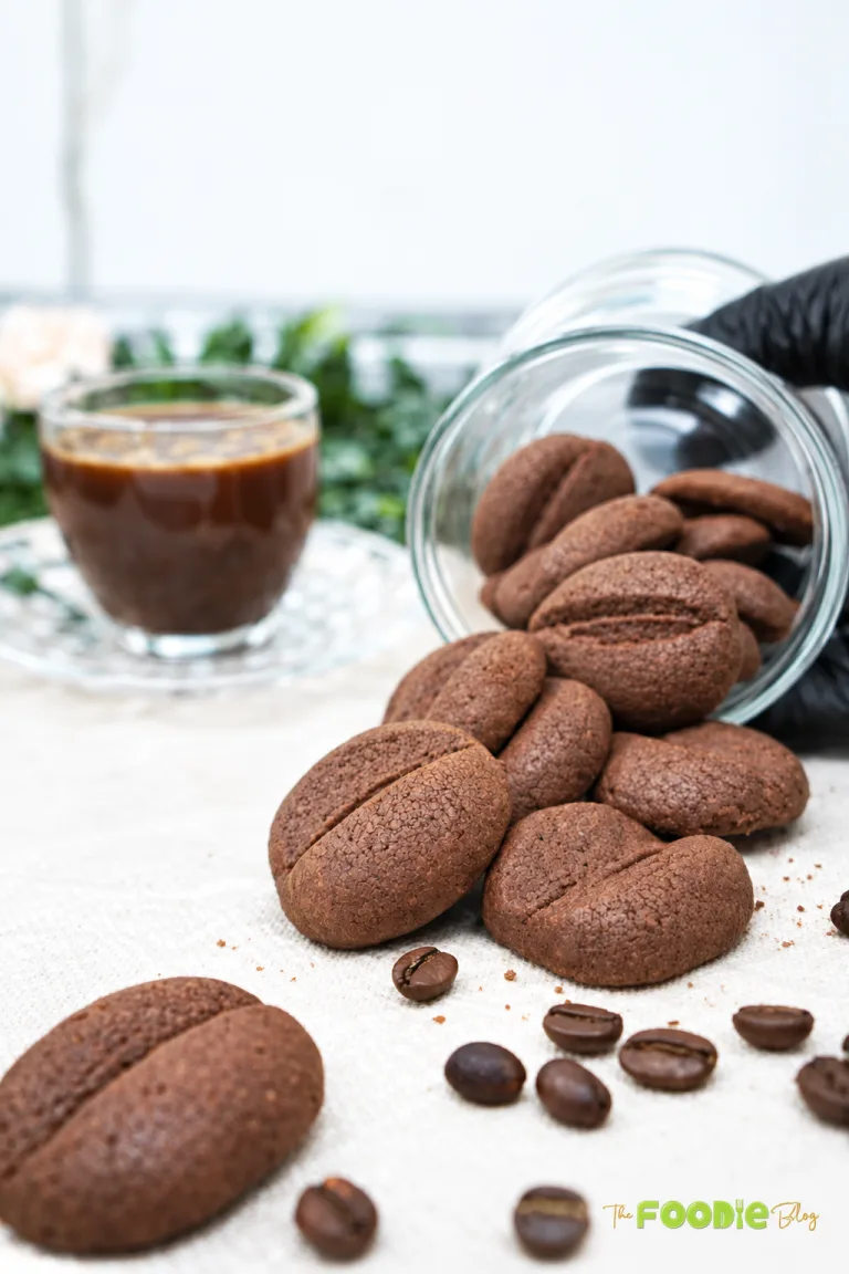 Coffee bean shaped chocolate coffee cookies served with a cup of coffee
