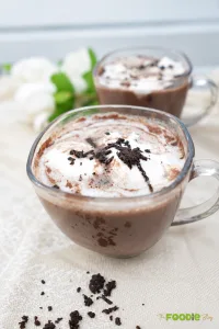 Homemade hot chocolate topped with whipped cream and chocolate shavings
