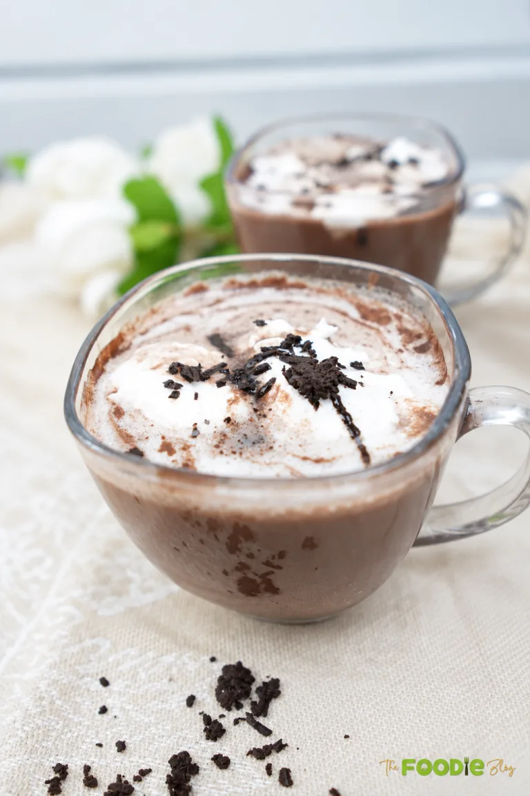 Homemade hot chocolate topped with whipped cream and chocolate shavings