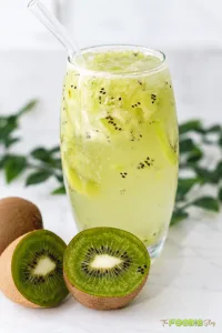 Refreshing kiwi lime drink with crushed kiwi, ice, and a glass straw