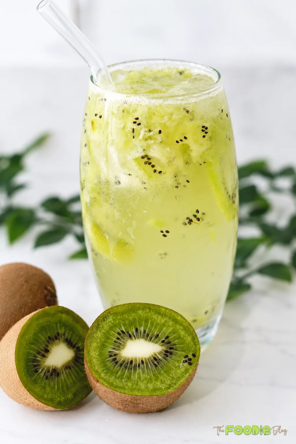 Refreshing kiwi lime drink with crushed kiwi, ice, and a glass straw