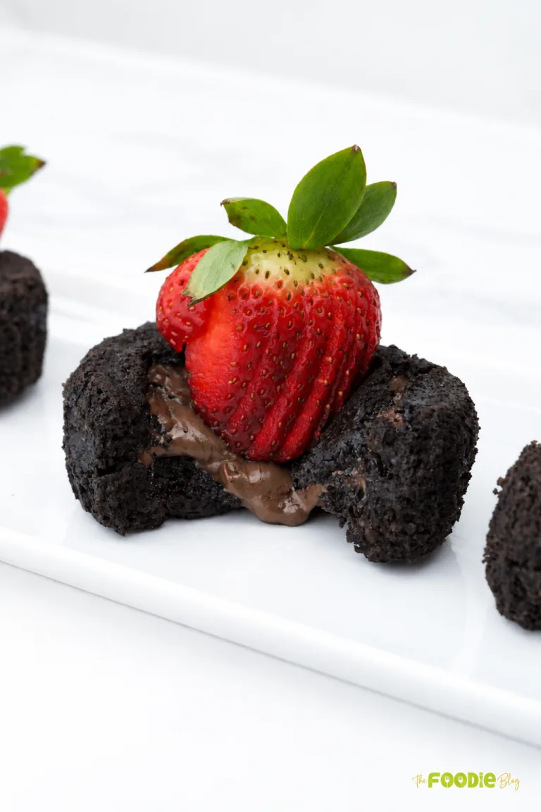Chocolate oatmeal lava cake with a gooey melted chocolate center topped with fresh strawberries