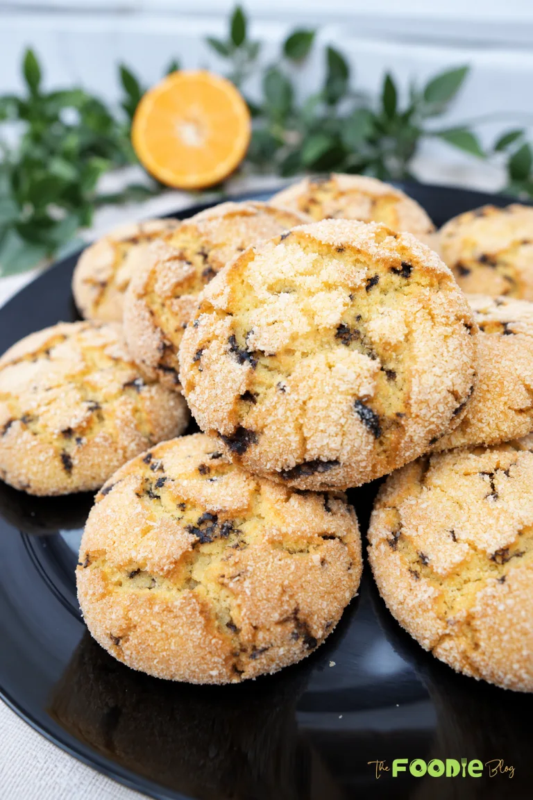 Stack of semolina cookies with chocolate sprinkles and coconut coating