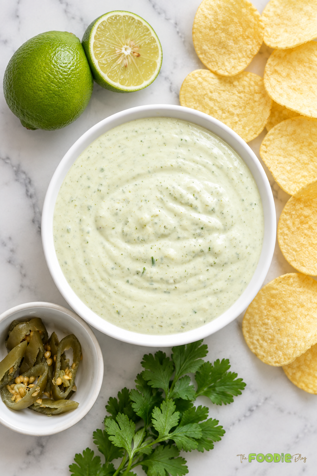 Tortilla chip dipped into creamy jalapeño ranch sauce