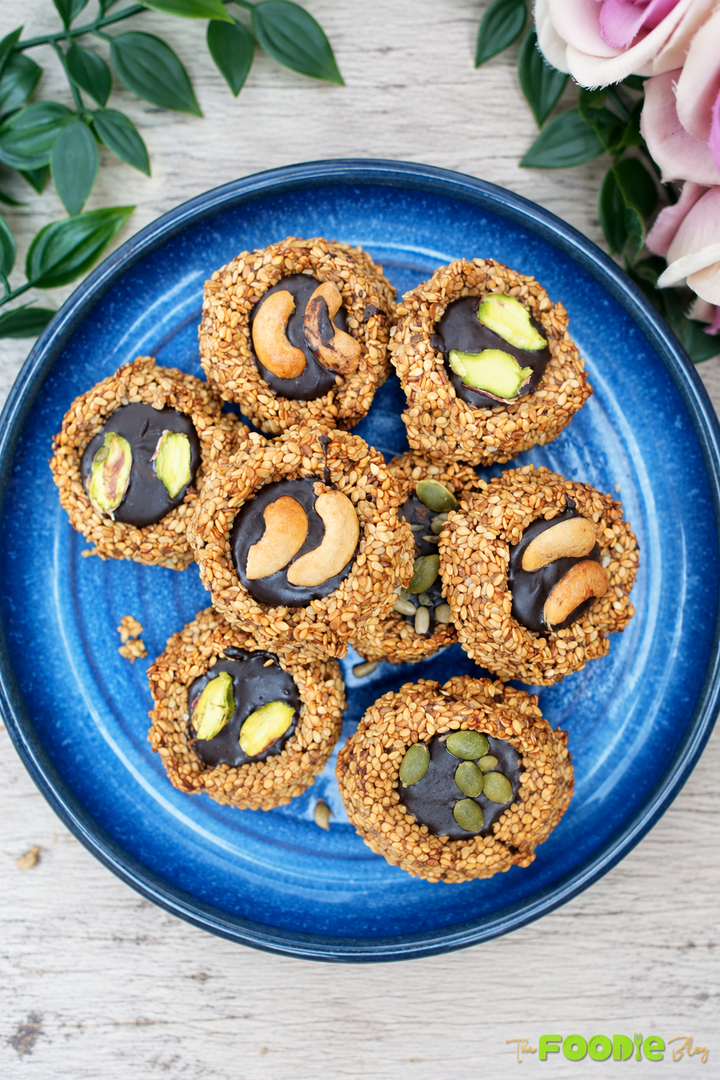 Sesame banana cookies filled with dark chocolate and topped with pistachios and cashews