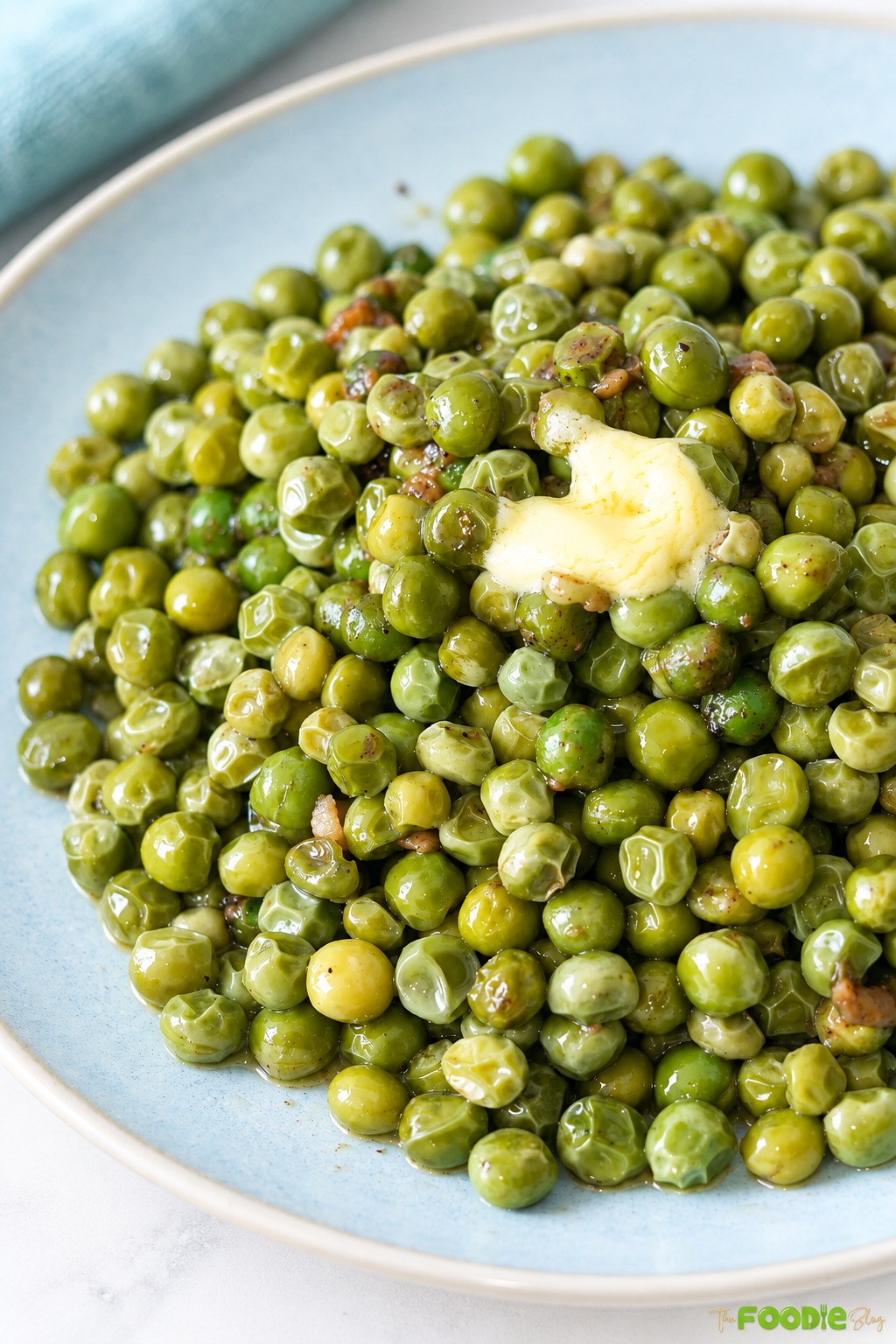Close-up of garlic butter peas coated in melted butter and black pepper