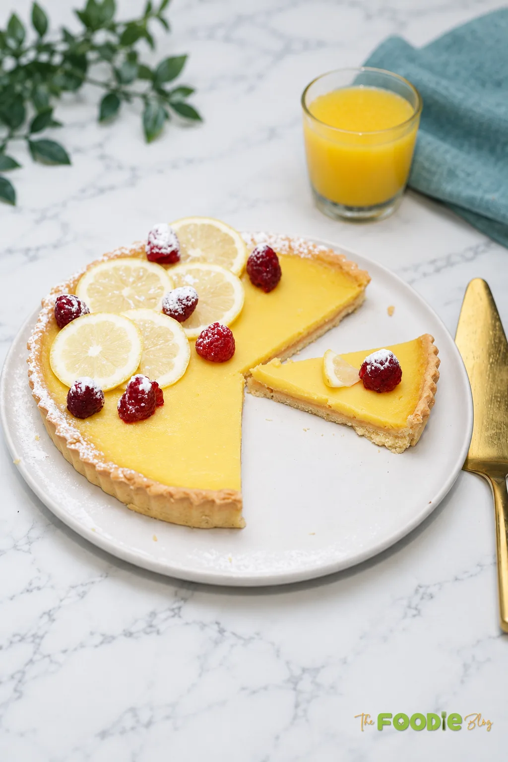Homemade lemon curd tart decorated with fresh lemon slices and raspberries