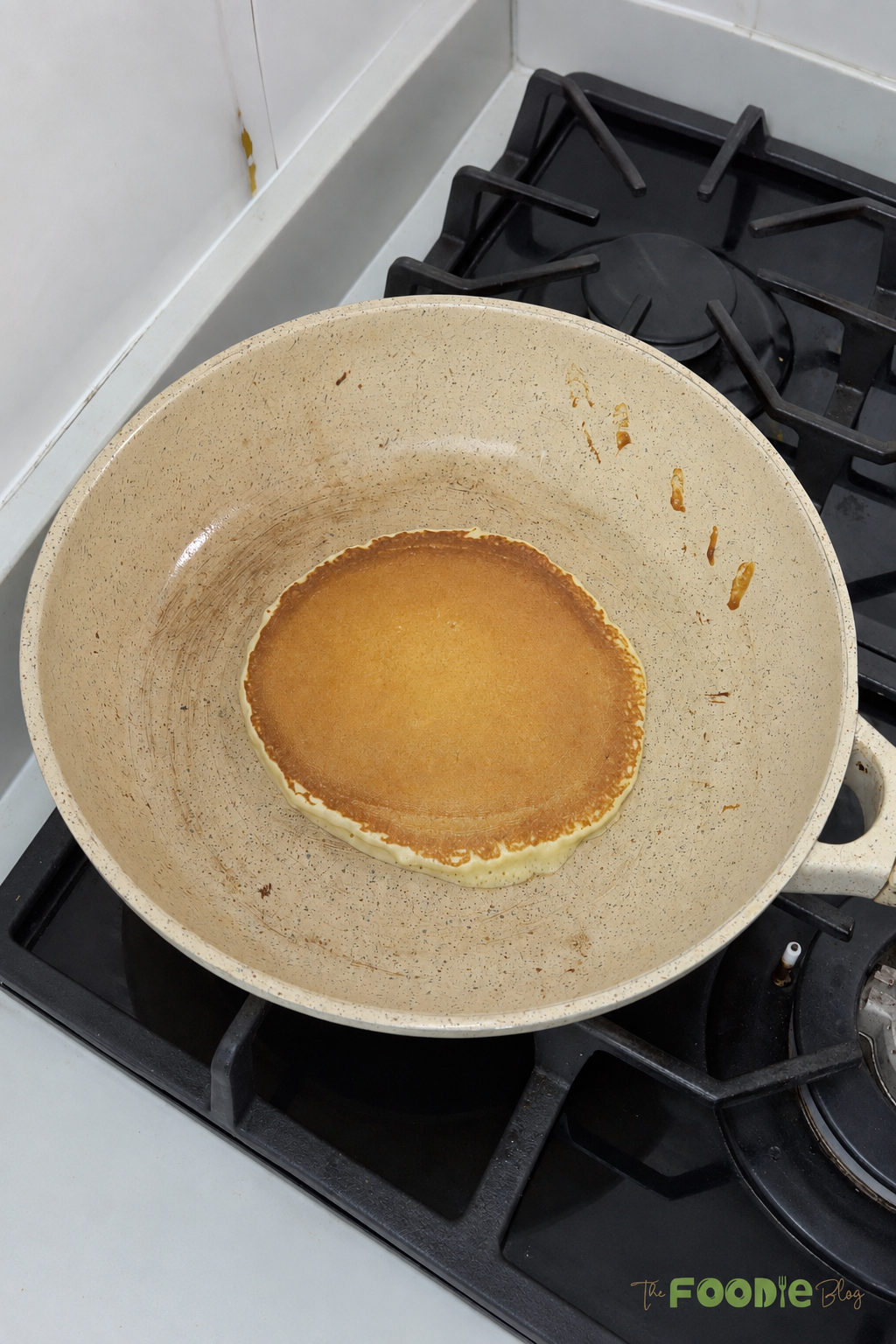 Golden protein pancake cooking in a skillet