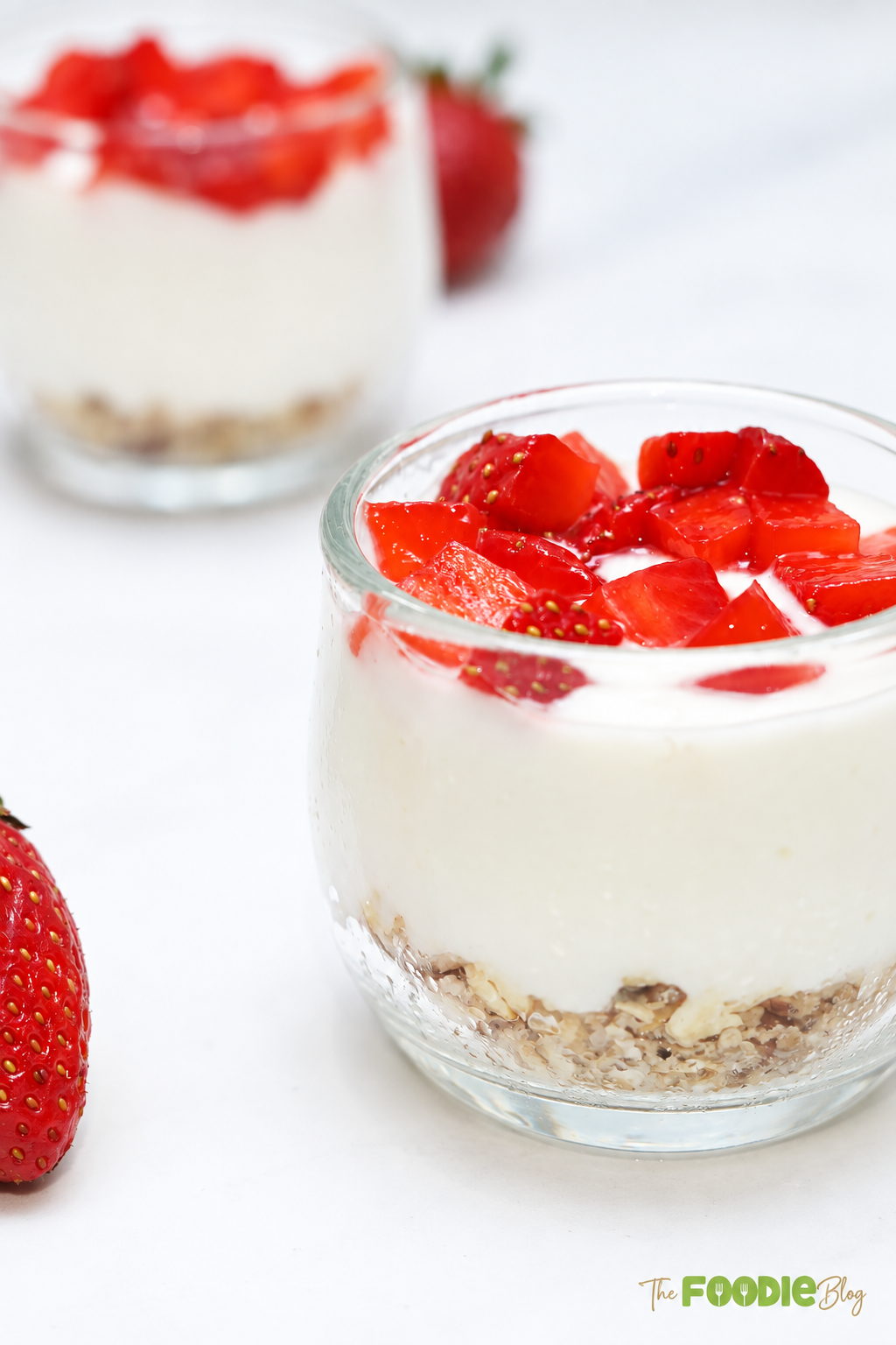 Close-up of creamy strawberry protein cheesecake cup with oat pecan crust