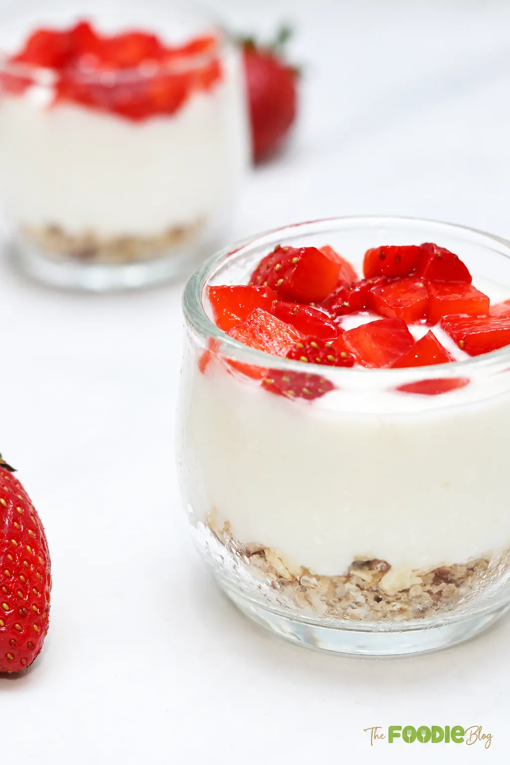 Close-up of creamy strawberry protein cheesecake cup with oat pecan crust