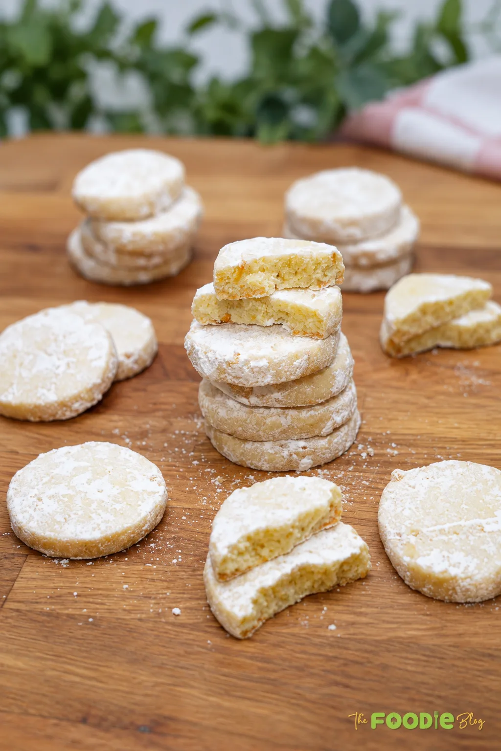 Homemade lime meltaway cookies stacked and dusted with powdered sugar