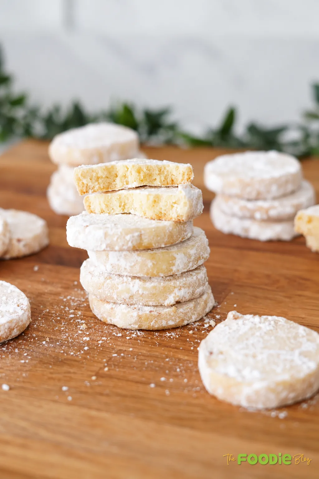 Close-up of broken lime meltaway cookies showing a soft crumb and powdered sugar coating