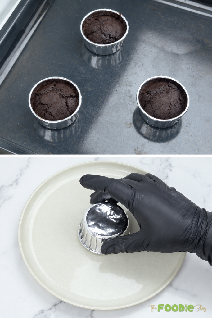 Baked chocolate oatmeal lava cake being unmolded from a foil cup onto a plate