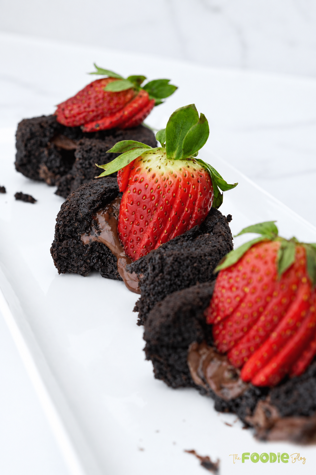 Gooey chocolate oatmeal lava cakes topped with sliced fresh strawberries