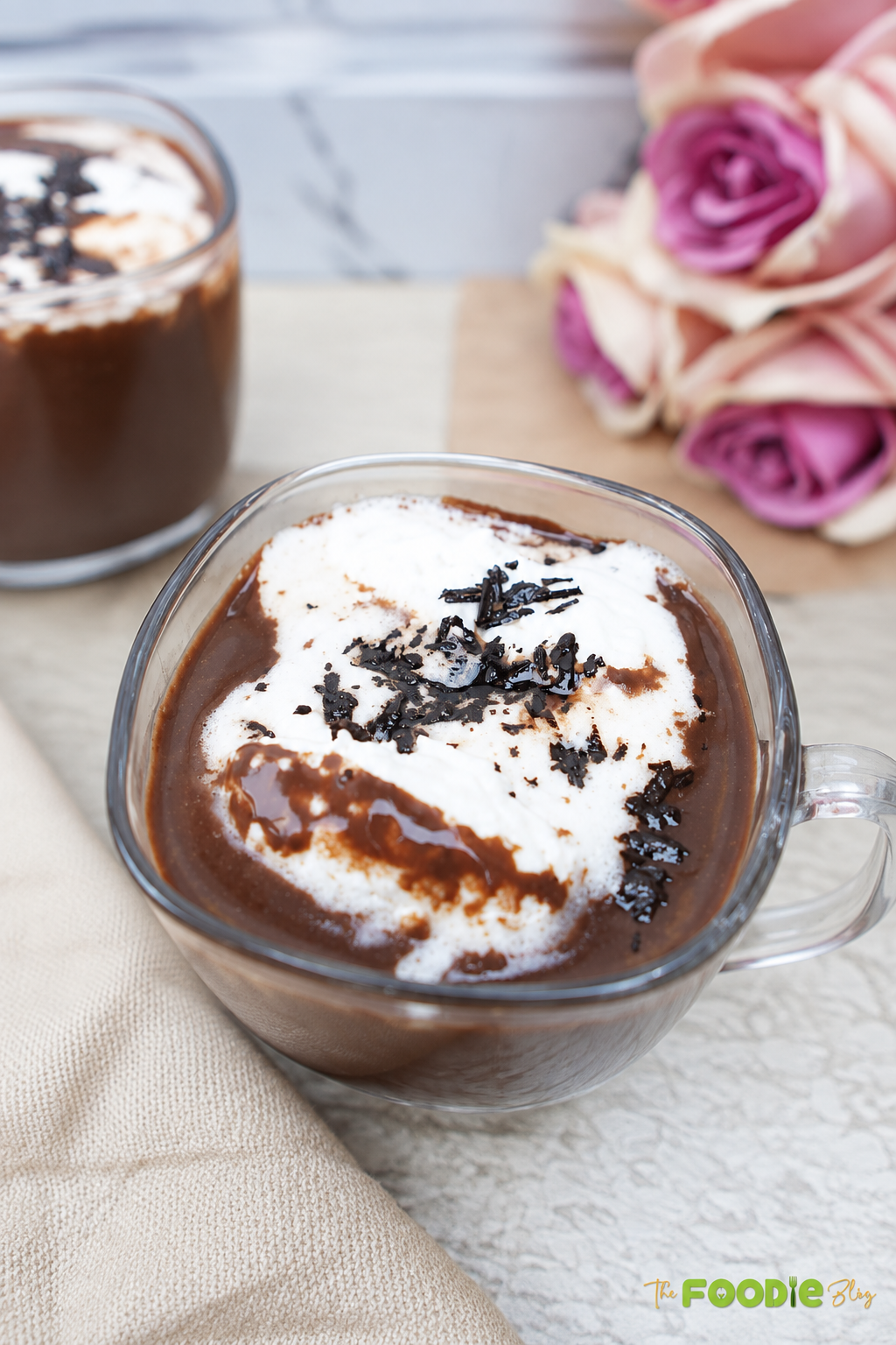 Creamy homemade hot chocolate with whipped cream and dark chocolate shavings