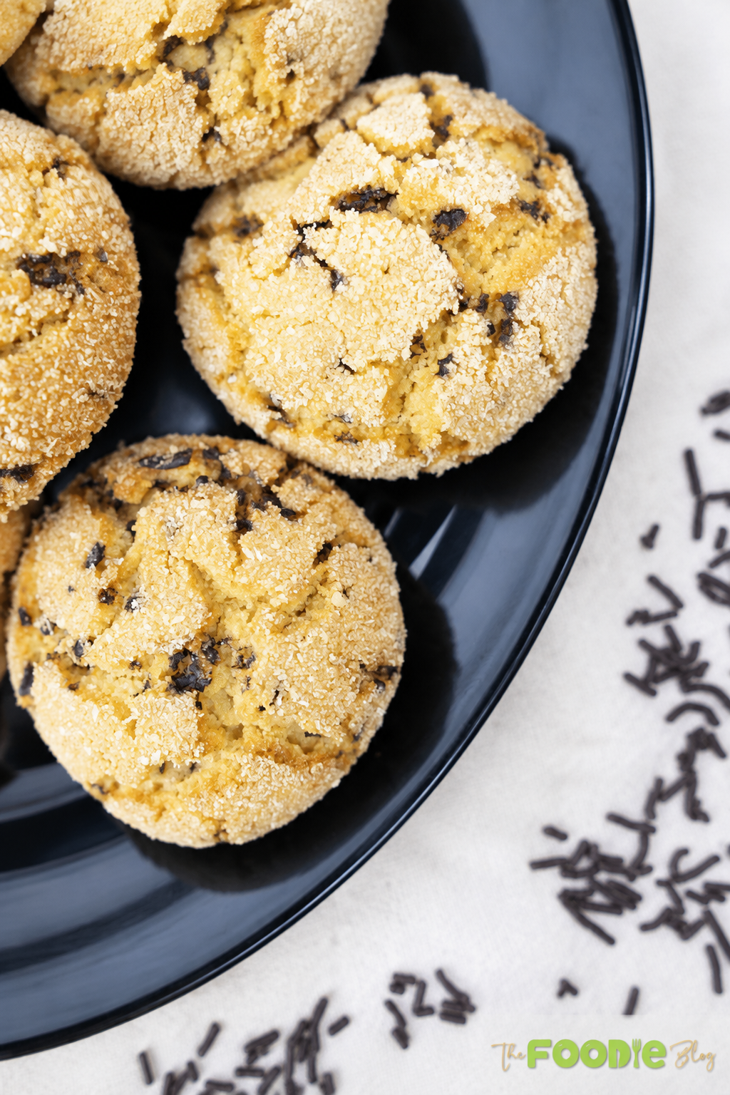 Close-up of semolina cookies with chocolate sprinkles on a black plate