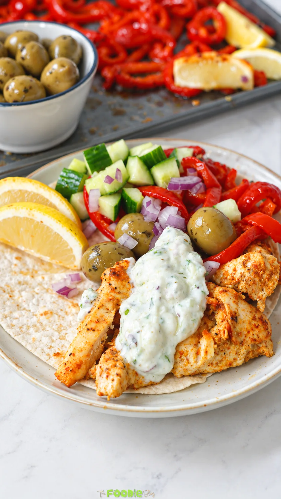Chicken pita topped with tzatziki, cucumber, roasted peppers, red onion, olives, feta, and lemon.