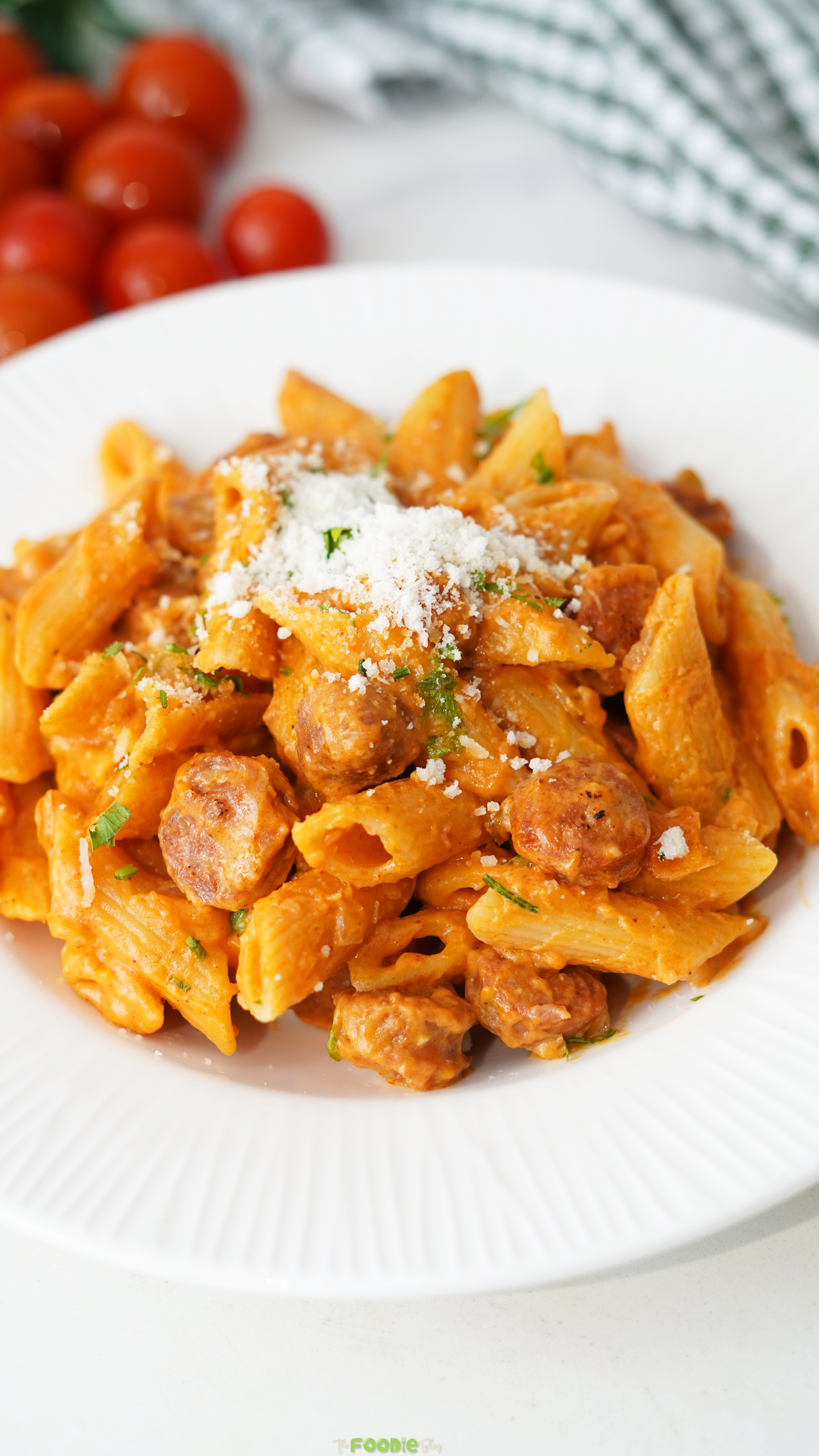 Creamy Cajun sausage pasta with penne and browned smoked sausage topped with grated Parmesan and fresh parsley.