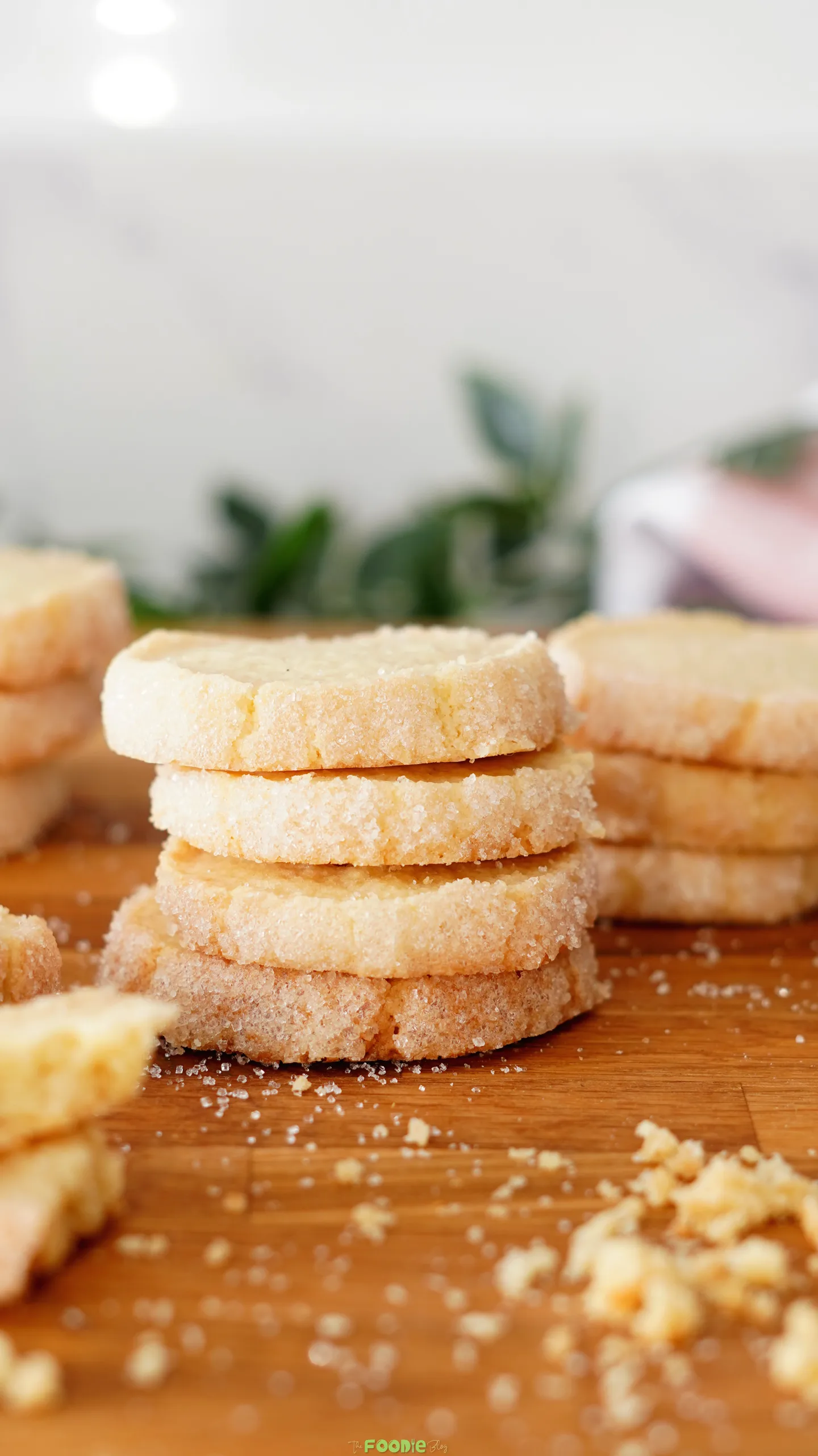 Stack of buttery French sable cookies with lightly golden sugar-coated edges.
