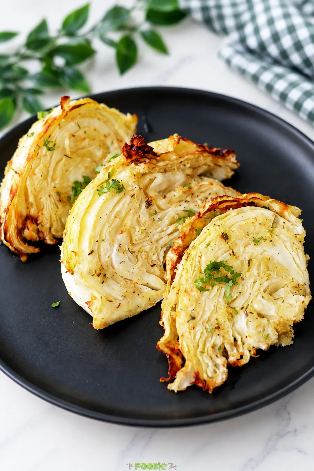Garlic Parmesan cabbage wedges cooked in the air fryer until golden around the edges.
