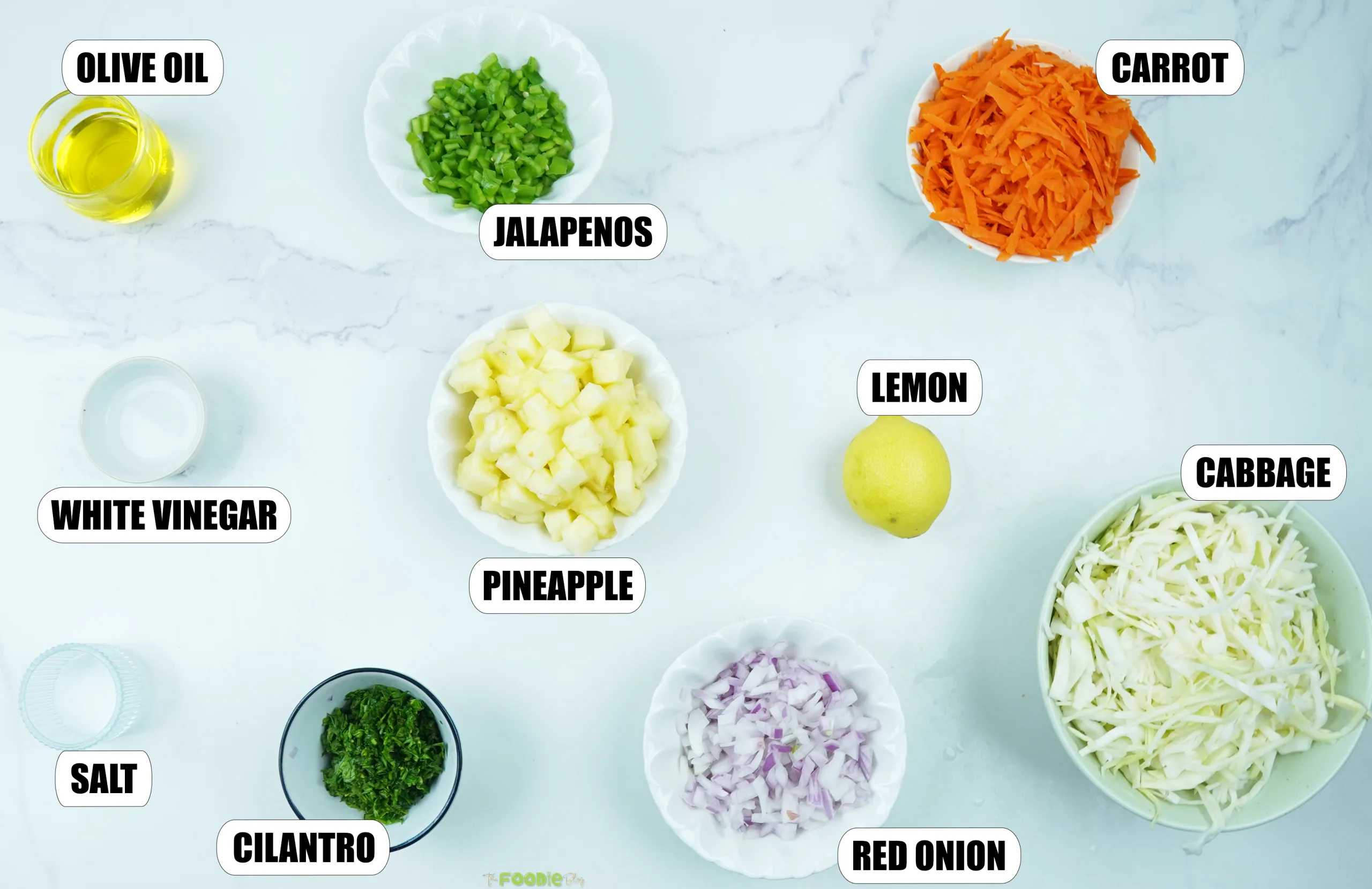 Olive oil, jalapeños, carrot, cabbage, pineapple, red onion, cilantro, lemon, white vinegar, and salt for pineapple coleslaw.