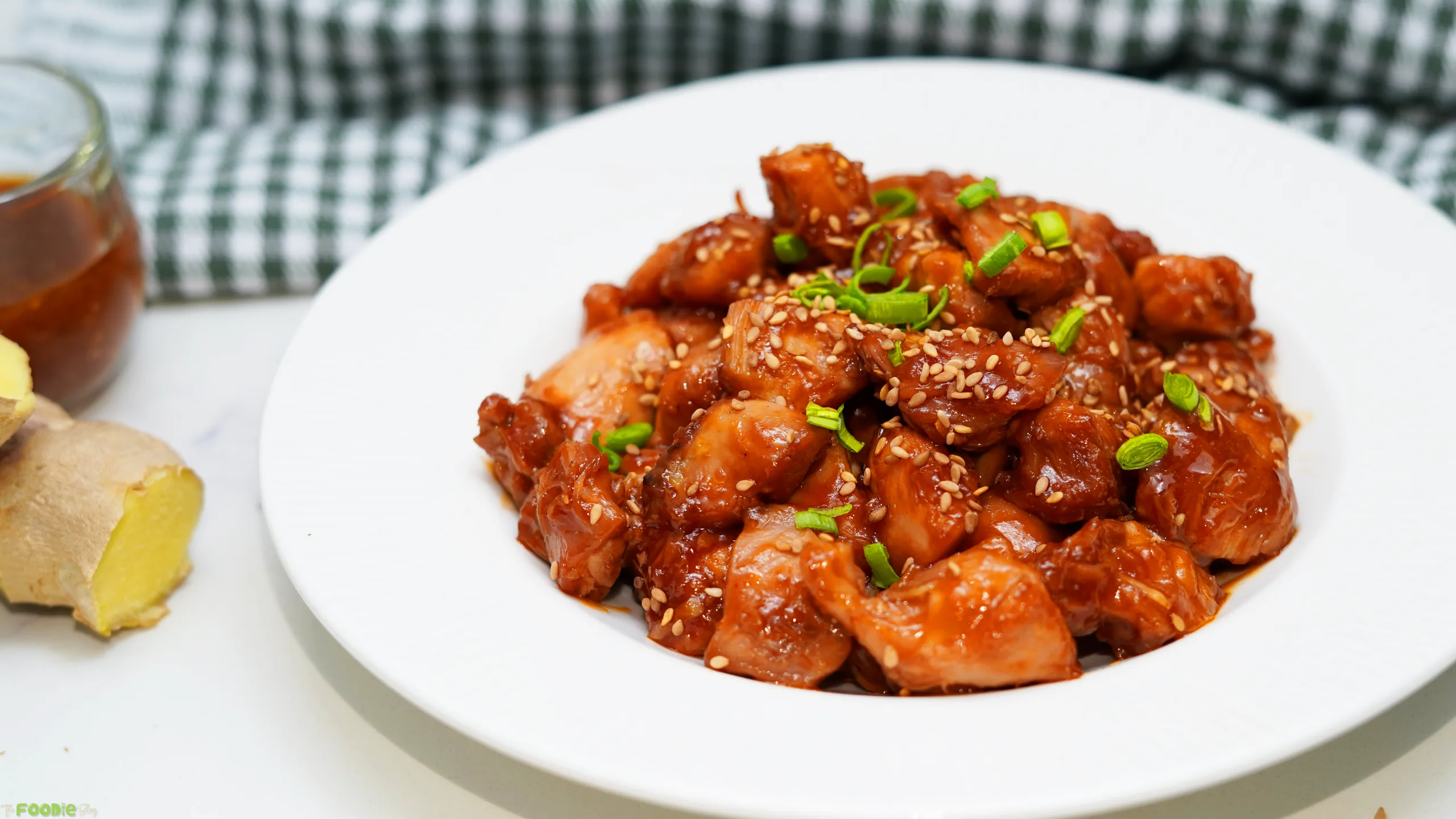 Sticky honey chicken thighs coated in glossy honey soy garlic sauce and topped with sesame seeds and green onions.