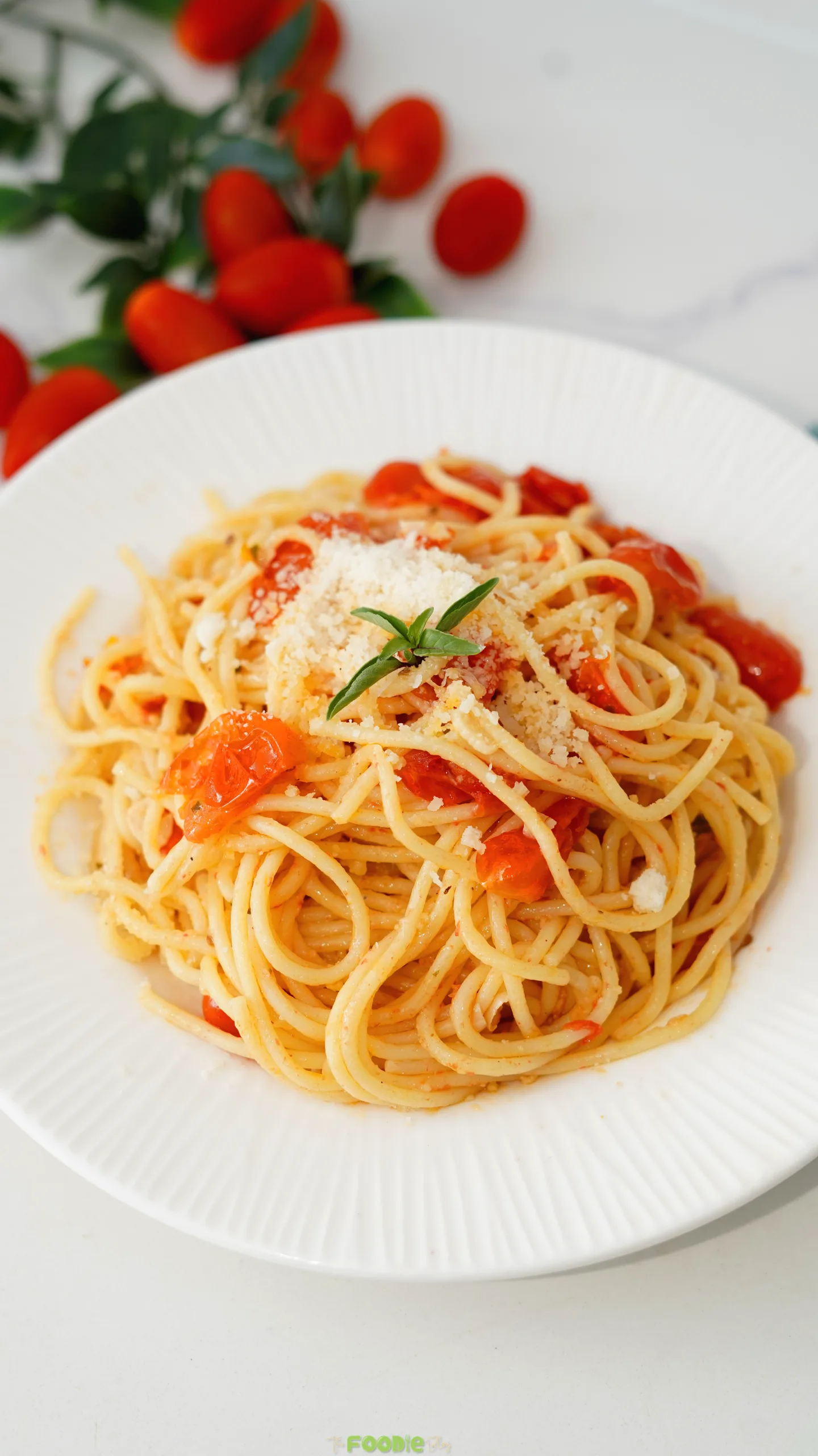 Tomato and garlic spaghetti topped with Parmesan and fresh herbs.