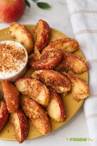 Crispy air fryer apple fries coated with cinnamon sugar and graham cracker crumbs served with creamy dip.