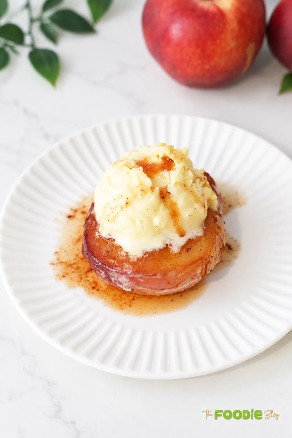 Warm baked peach half topped with vanilla ice cream and cinnamon honey sauce.