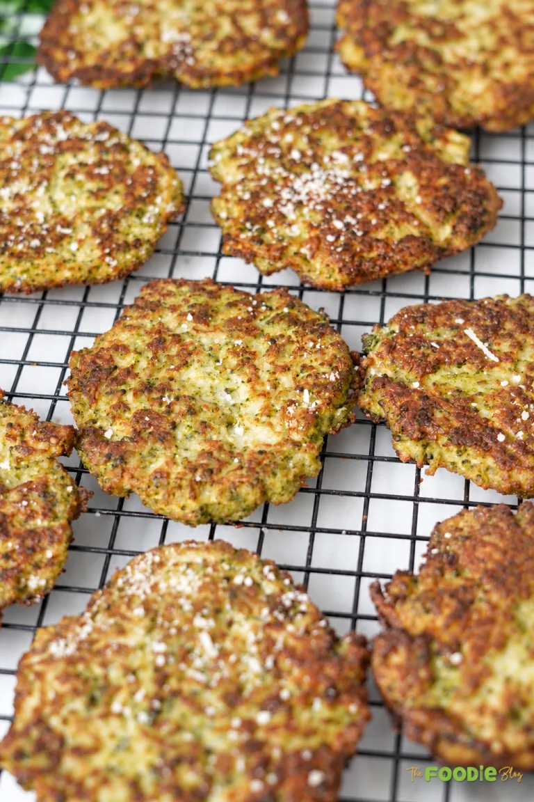 Crispy broccoli fritters cooling on a wire rack after frying.