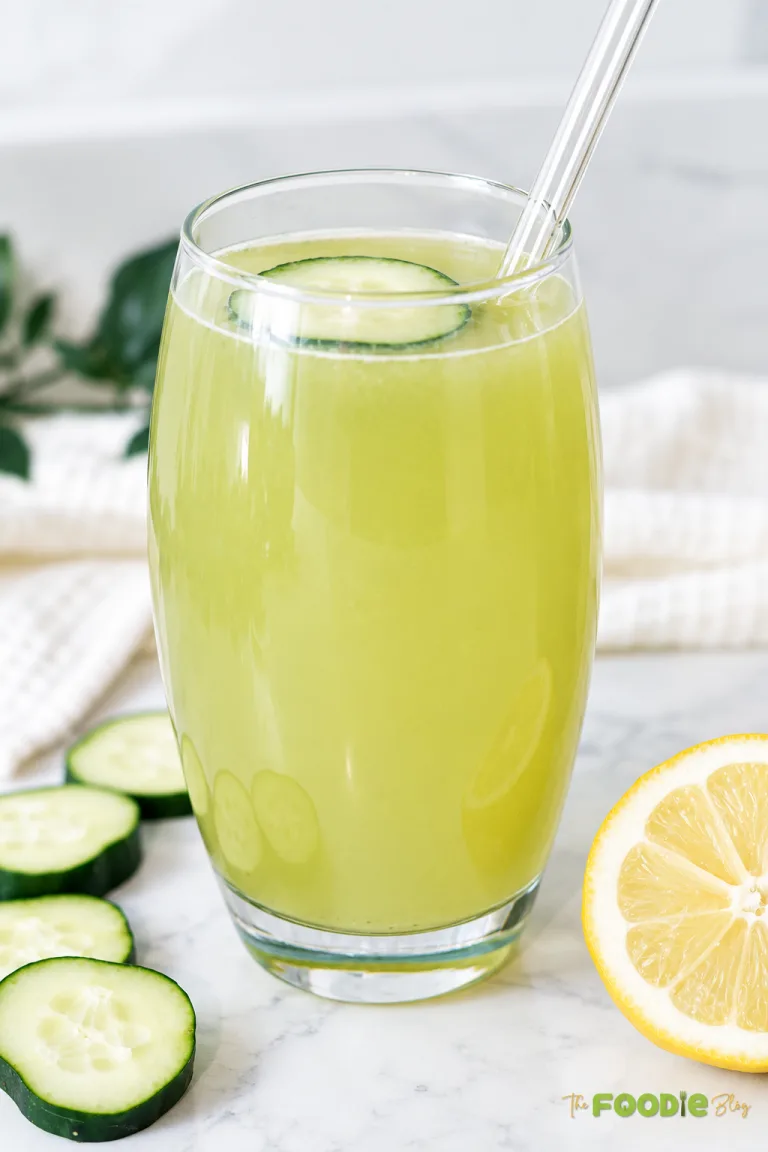 Homemade cucumber lemonade served in two glasses with fresh cucumber slices and lemon.