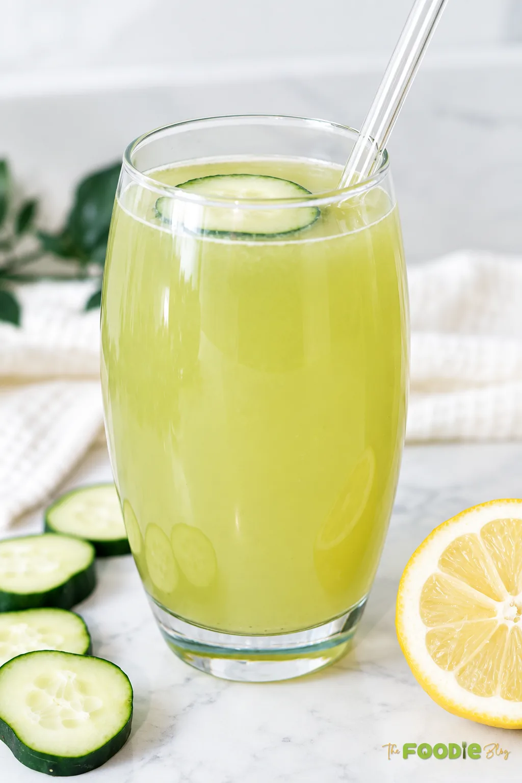 Homemade cucumber lemonade served in two glasses with fresh cucumber slices and lemon.