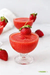 Frozen strawberry daiquiri drink made with strawberries, lime juice, simple syrup, and white rum.