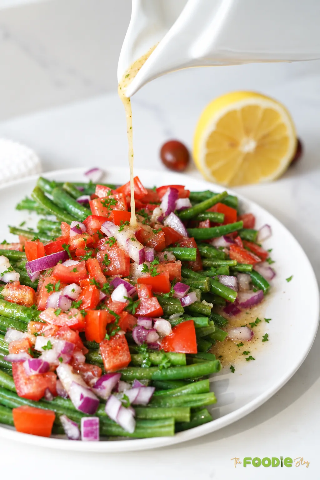 Green bean and tomato salad with red onion, parsley, and lemon Dijon dressing.
