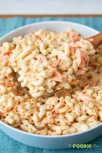Close-up of creamy Hawaiian macaroni salad with shredded carrots and green onions.