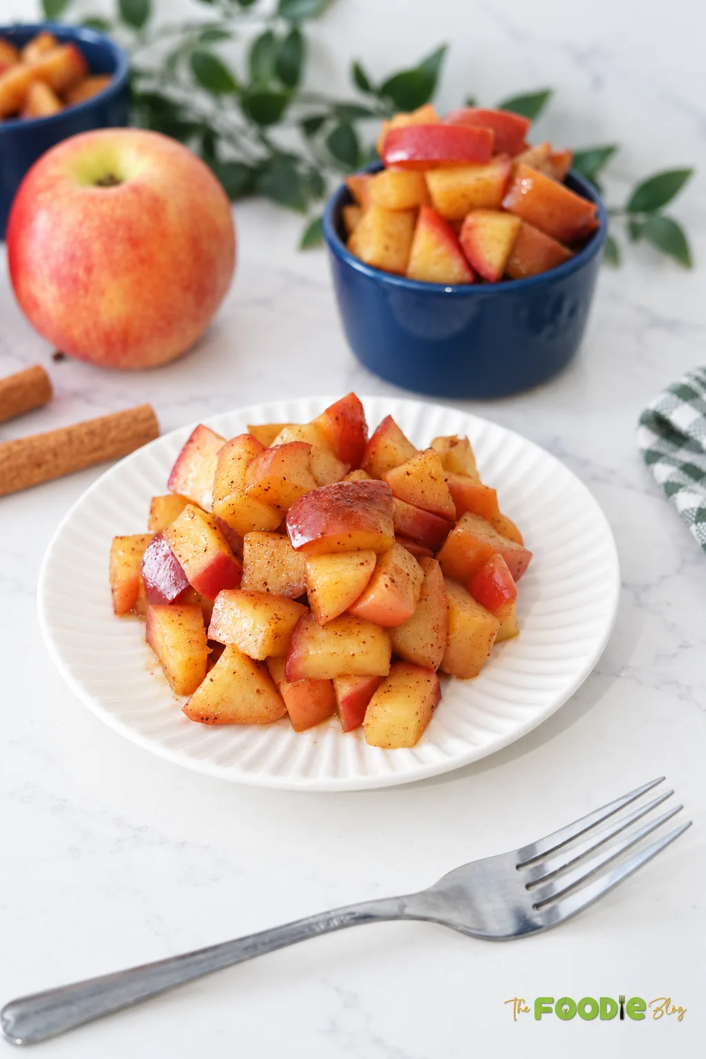 Easy cinnamon apples with maple syrup served on a white plate