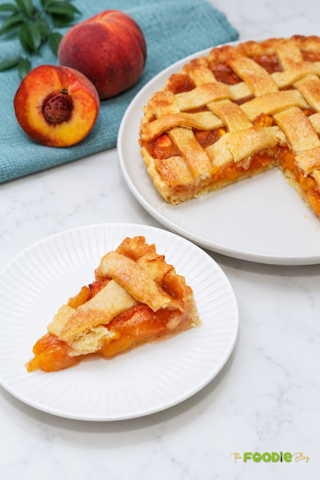 Slice of fresh peach pie with juicy peach filling and flaky lattice crust beside the whole pie.