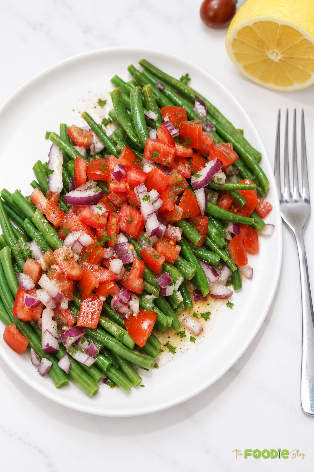 Fresh green bean and tomato salad served with red onion, parsley, and lemon dressing.
