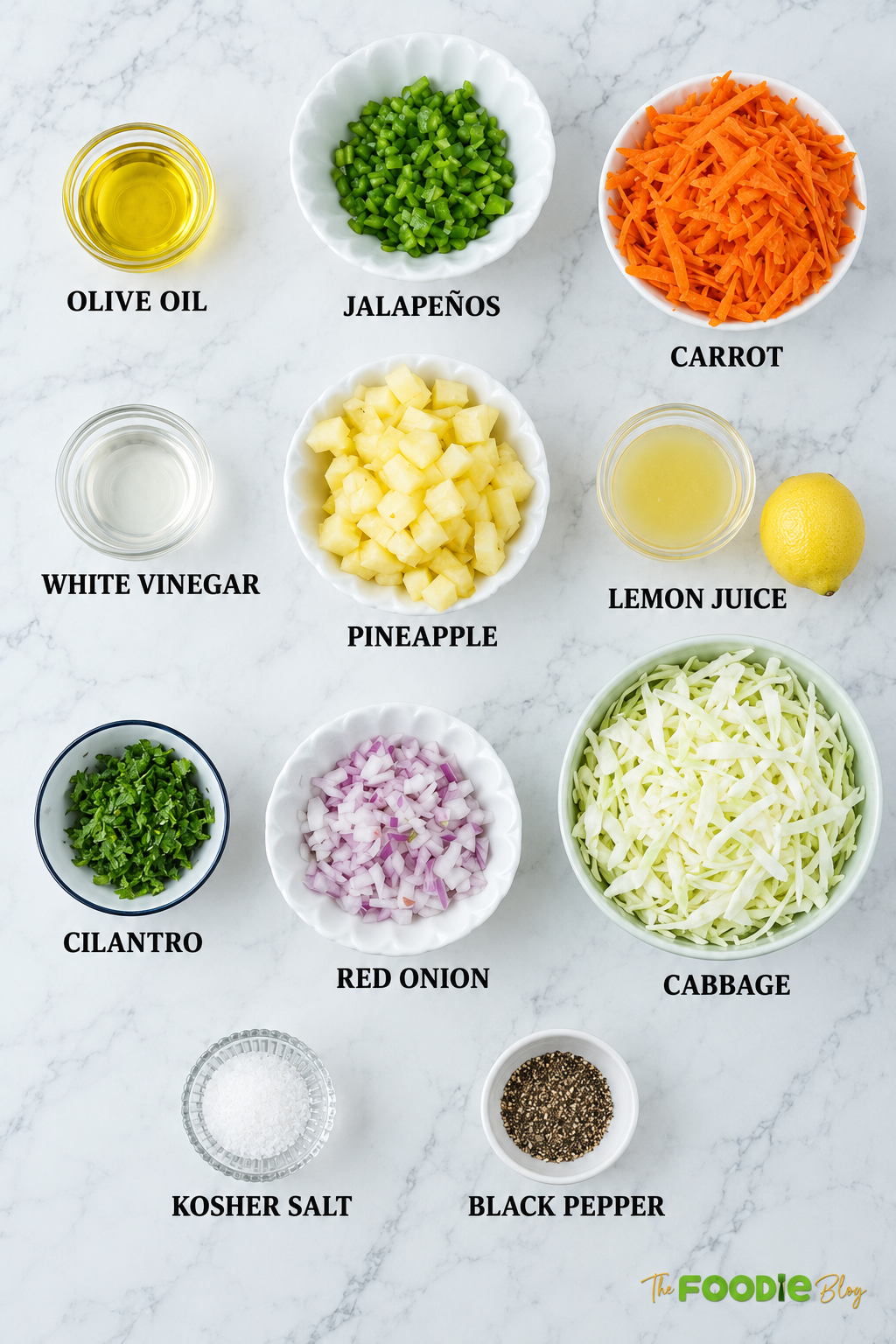 Ingredients for pineapple coleslaw including cabbage, carrots, pineapple, red onion, cilantro, jalapeños, lemon juice, vinegar, olive oil, salt, and pepper.