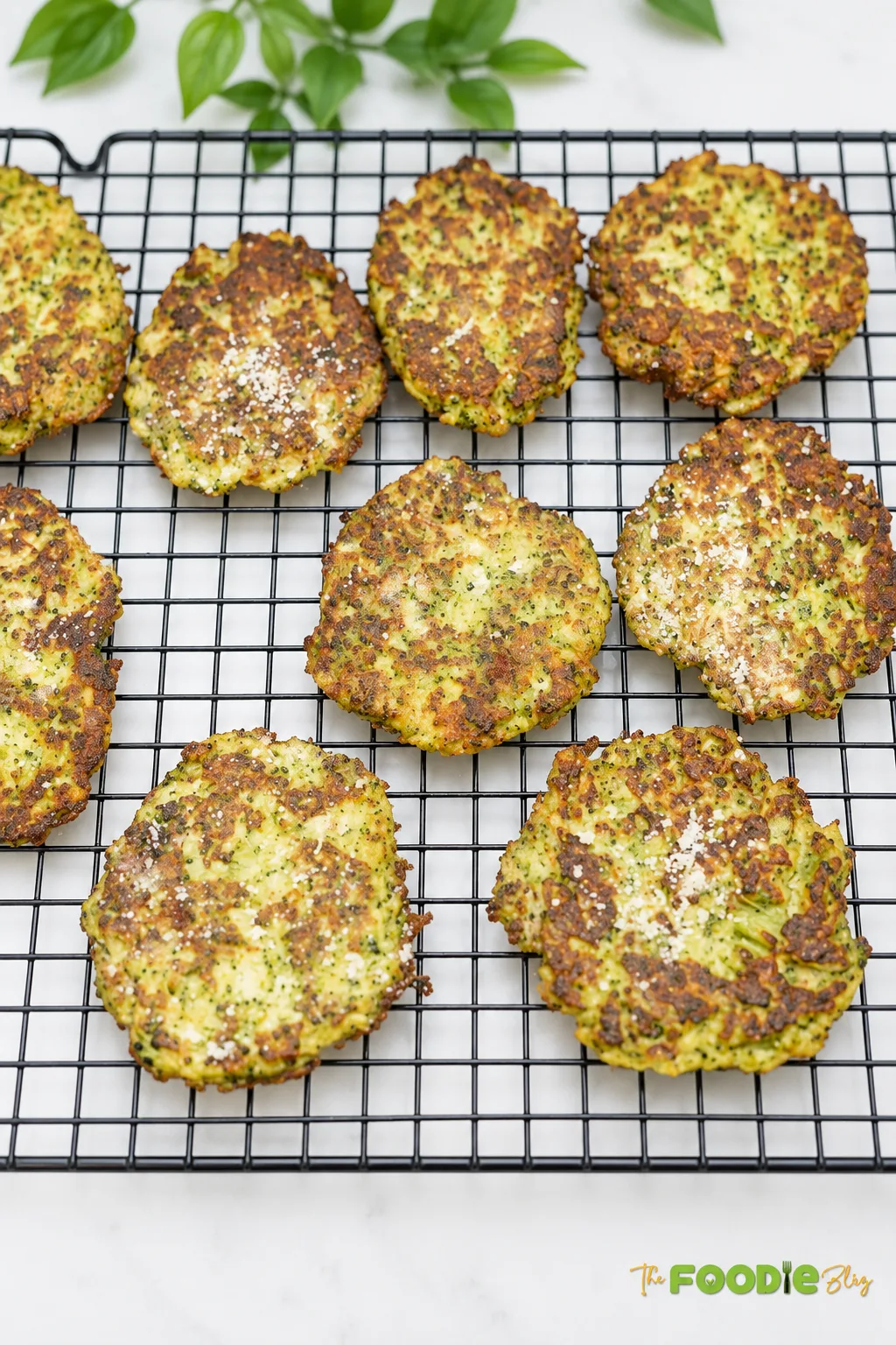 Homemade broccoli fritters with crispy golden edges on a wire rack.