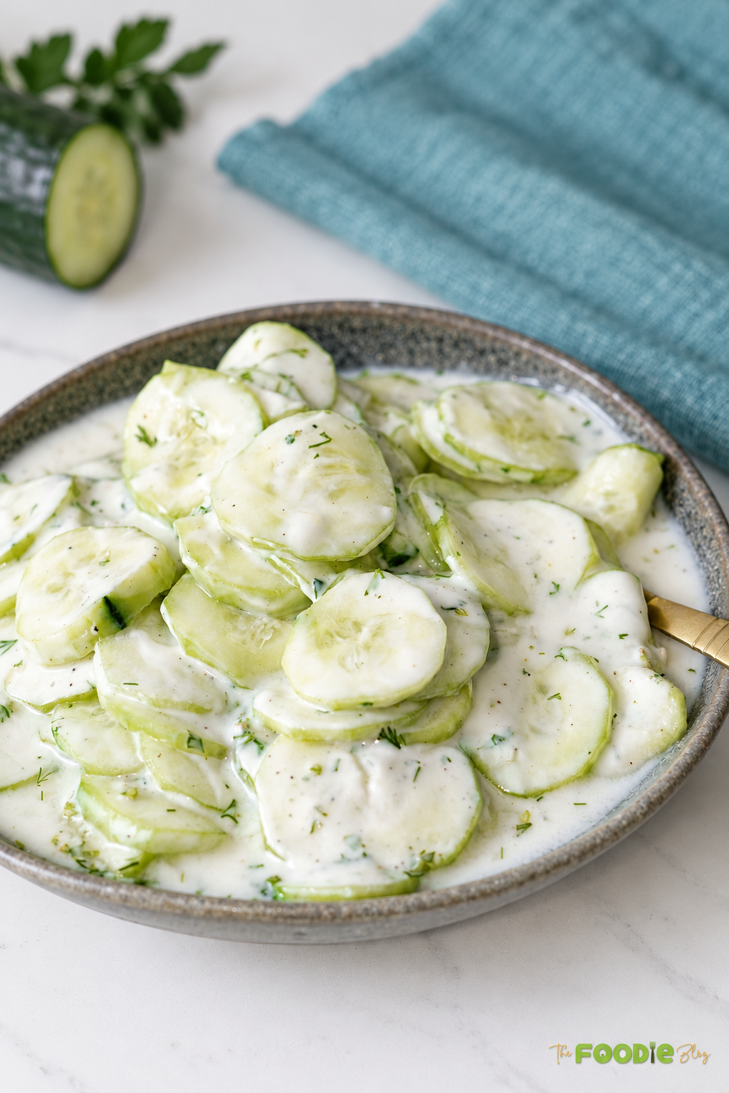 Creamy cucumber salad with fresh dill and black pepper served in a rustic bowl.