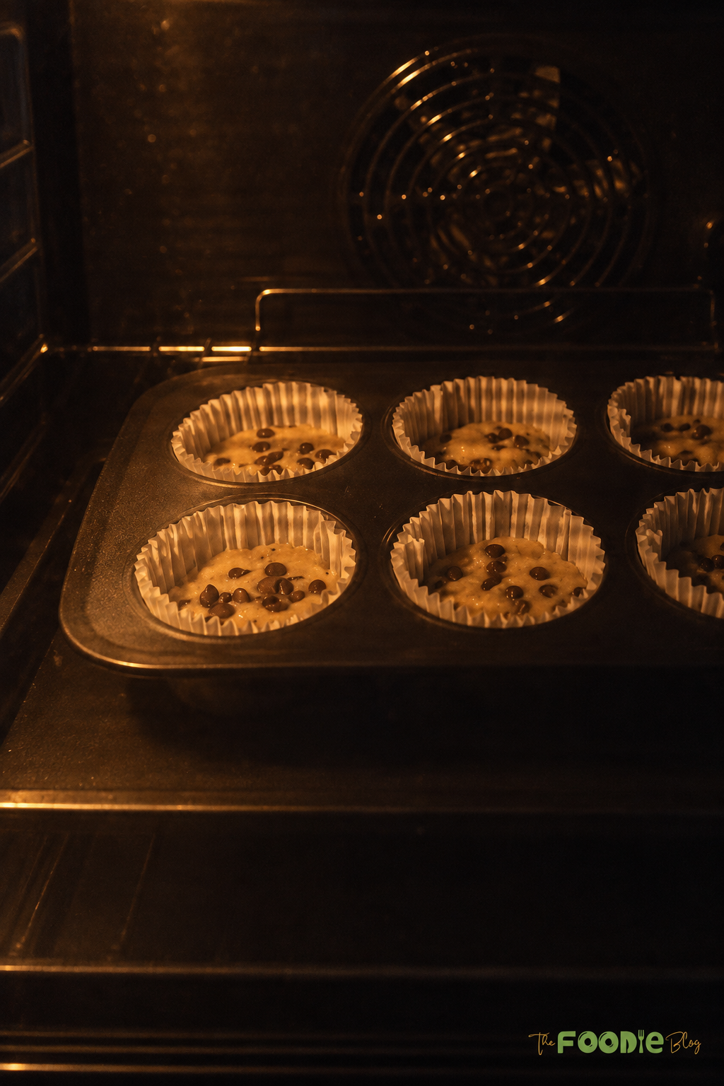 Banana protein muffins with chocolate chips baking in the oven.