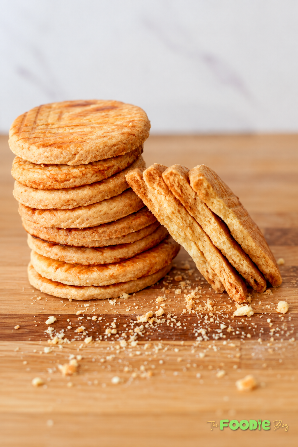 Freshly baked Galettes Bretonnes with golden brown tops and decorative fork marks on a baking surface.