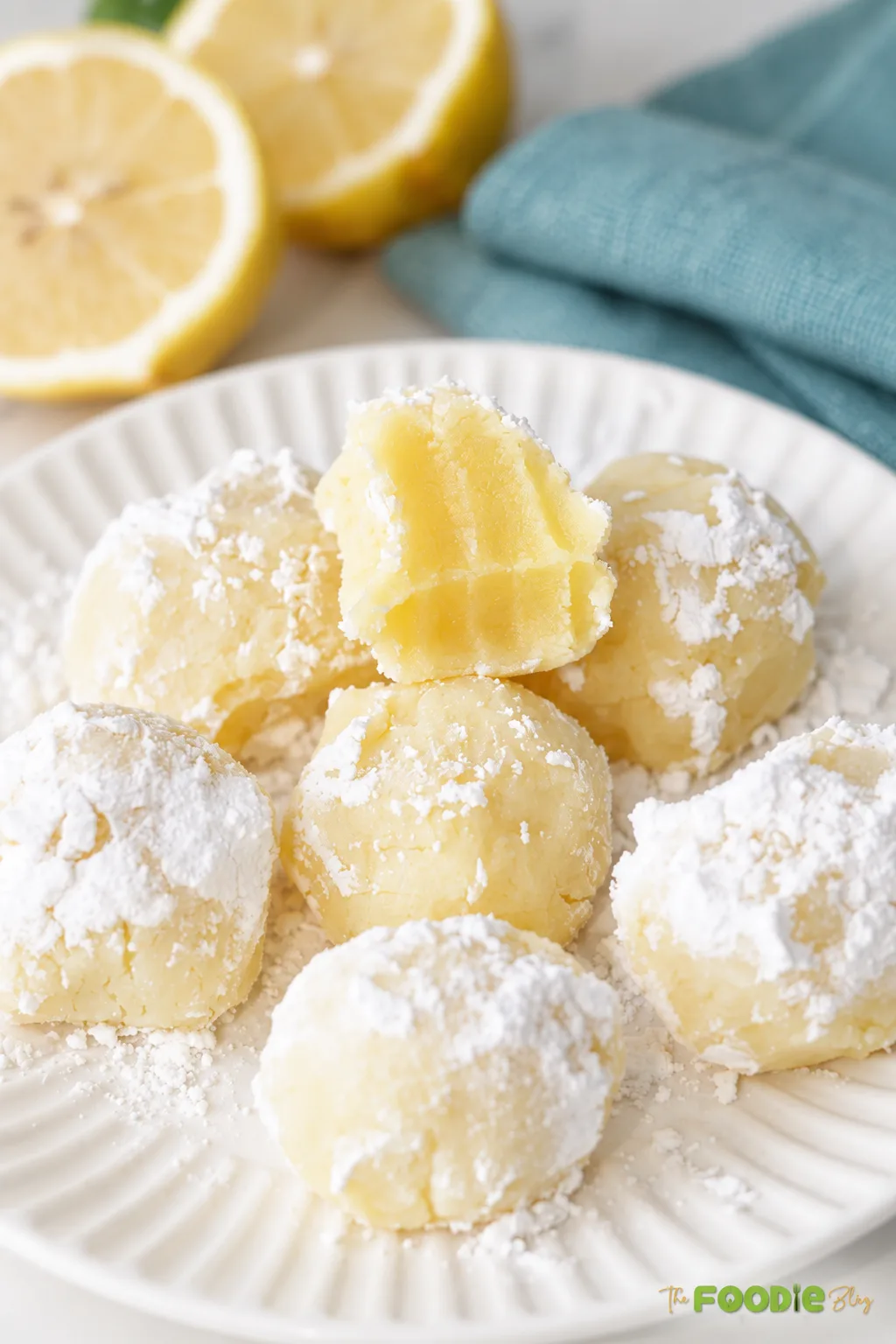 White chocolate lemon truffles with a creamy center and powdered sugar coating