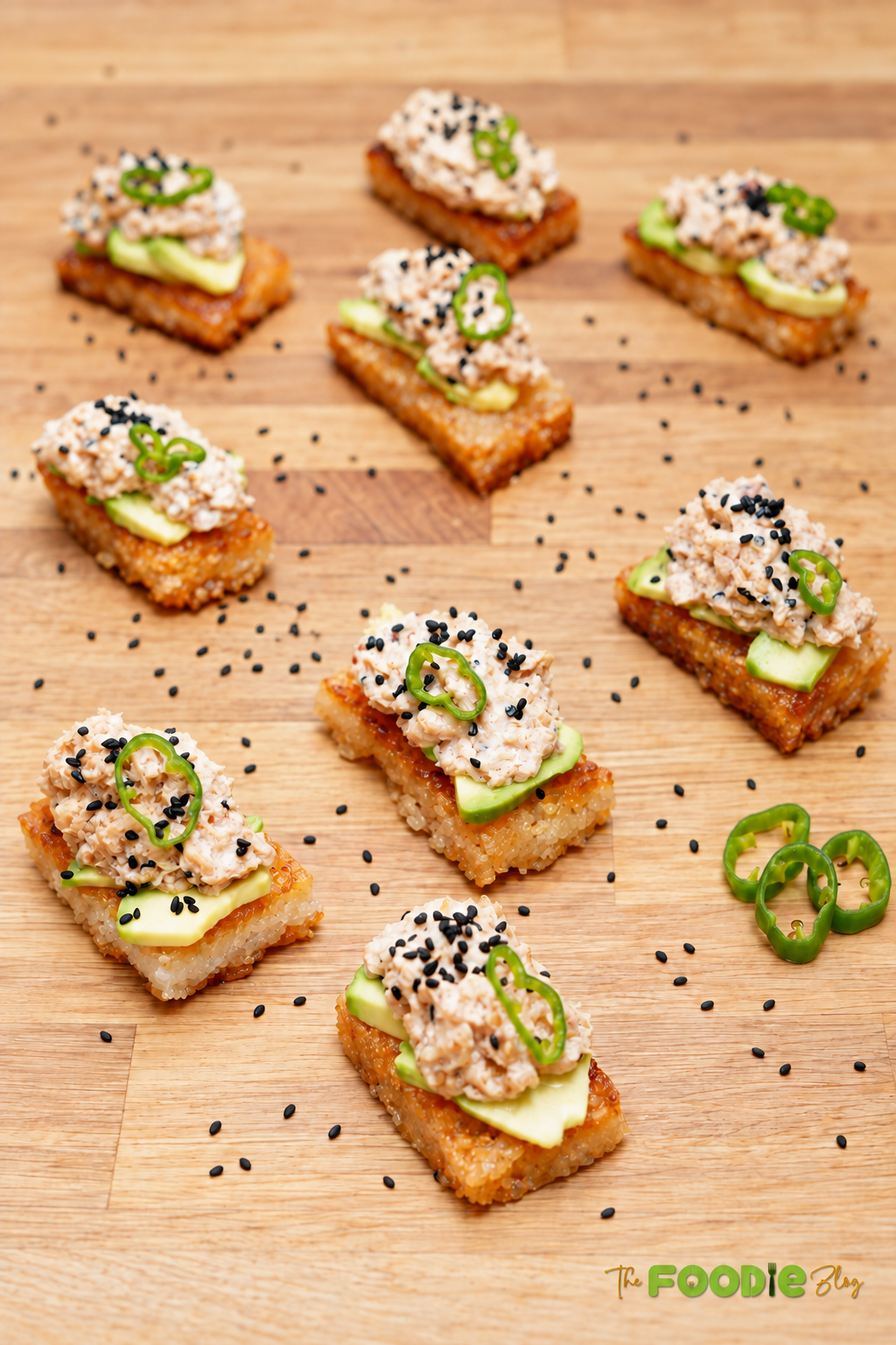 Crispy rice topped with avocado, spicy tuna, black sesame seeds, and sliced green chili.