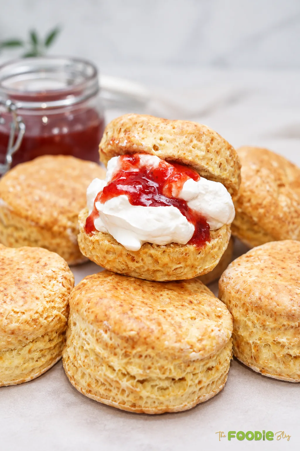 Traditional English scones served with whipped cream and strawberry jam.